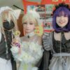 Three cosplayers in vibrant costumes and accessories pose for a photo, highlighting creativity and style.
