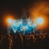 Energetic live music performance at night with a lively crowd.