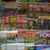A vibrant display of magazines in a newsstand, showcasing various colorful covers and headlines.