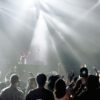 DJ performing in a lively nightclub with a crowd enjoying the vibrant atmosphere.