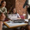 Engaging film crew capturing a scene indoors with diverse team and clapperboard.