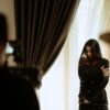 A woman actor performing a scene indoors, captured with dramatic lighting and intense emotion.