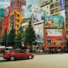 Street view of Akihabara, Tokyo with colorful billboards and bustling activity.