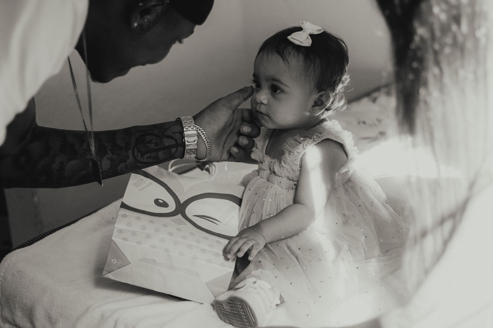 A touching black and white photograph of a father gently touching his daughter's face.