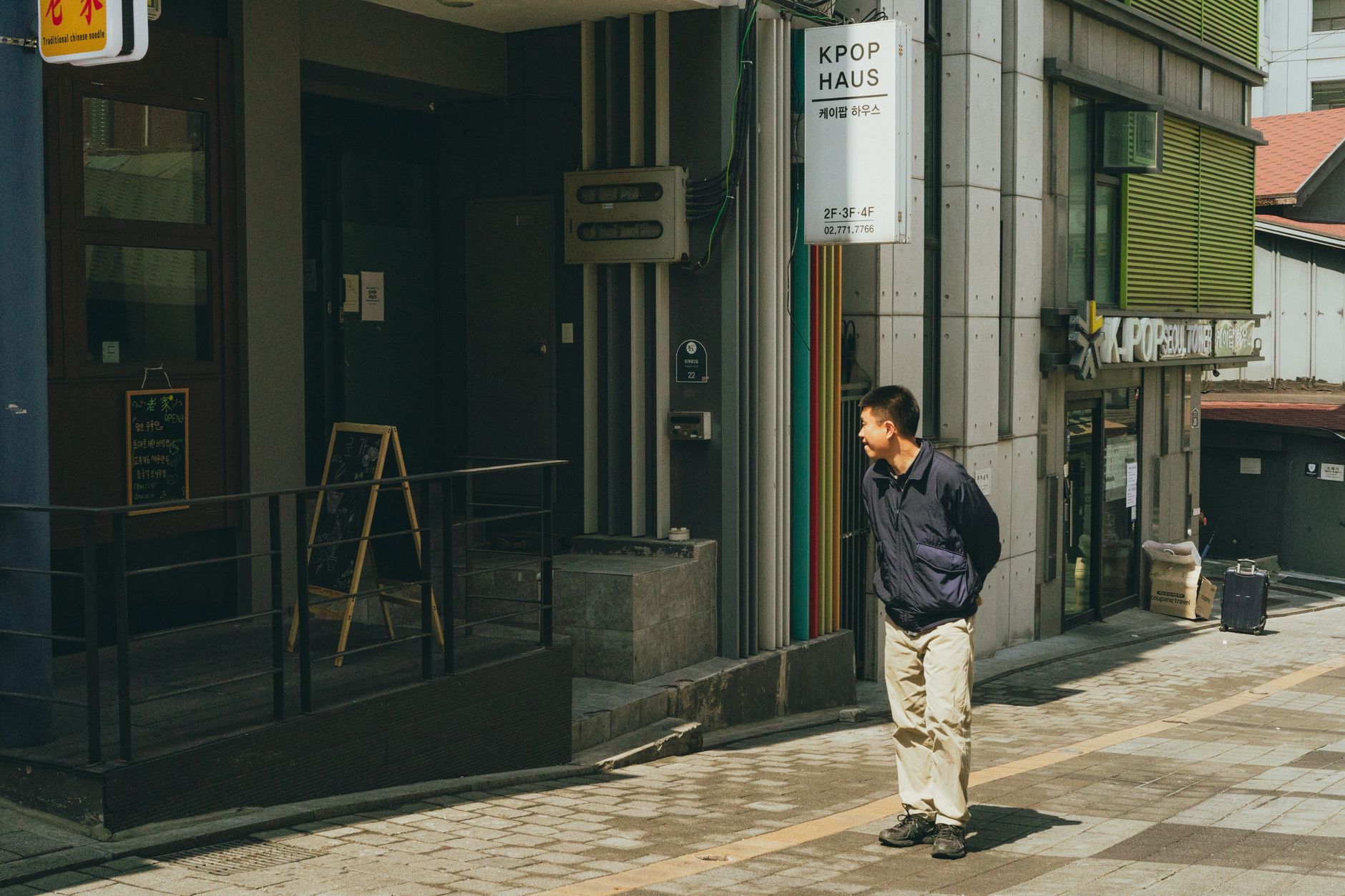 A man walks in front of a K-pop themed building in downtown Seoul, South Korea.