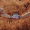 Heartwarming photo of parents holding baby shoes symbolizing a new journey in Sinaloa, Mexico.