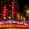 Vibrant night scene of Radio City Music Hall in NYC's Rockefeller Center.