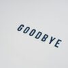 Simple typography displaying the word goodbye on a clean white background, offering ample copy space.