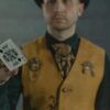 A magician displays the King of Spades card, creating intrigue and focus in a dimly lit scene.