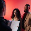 Couple reading script in a studio with warm lighting for film or theater production.