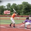 Youth baseball game with pitcher, batter, and catcher in action on a sunny day outdoors.