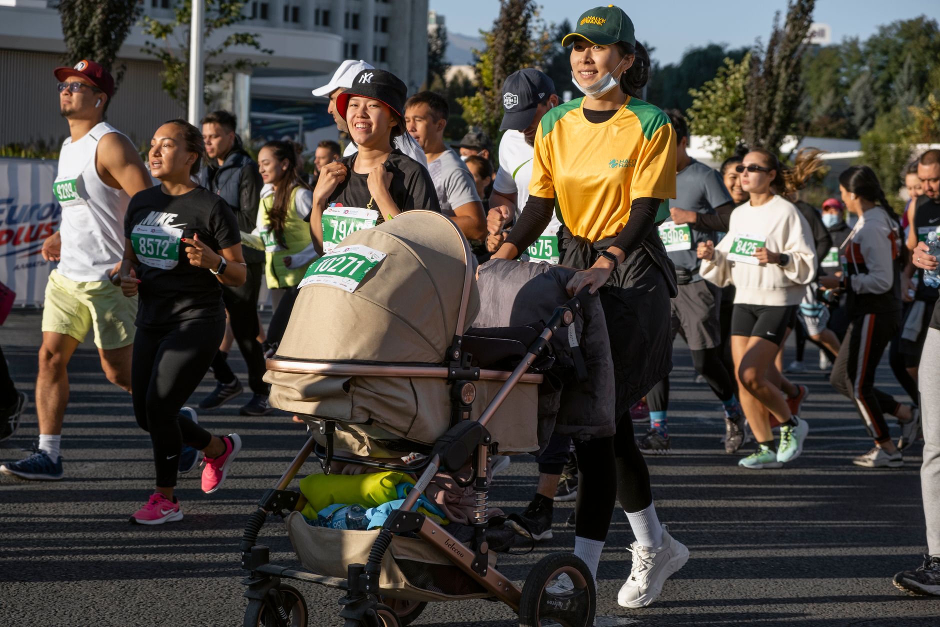 Group of diverse marathon runners in athletic gear participating in an outdoor race with positive energy.