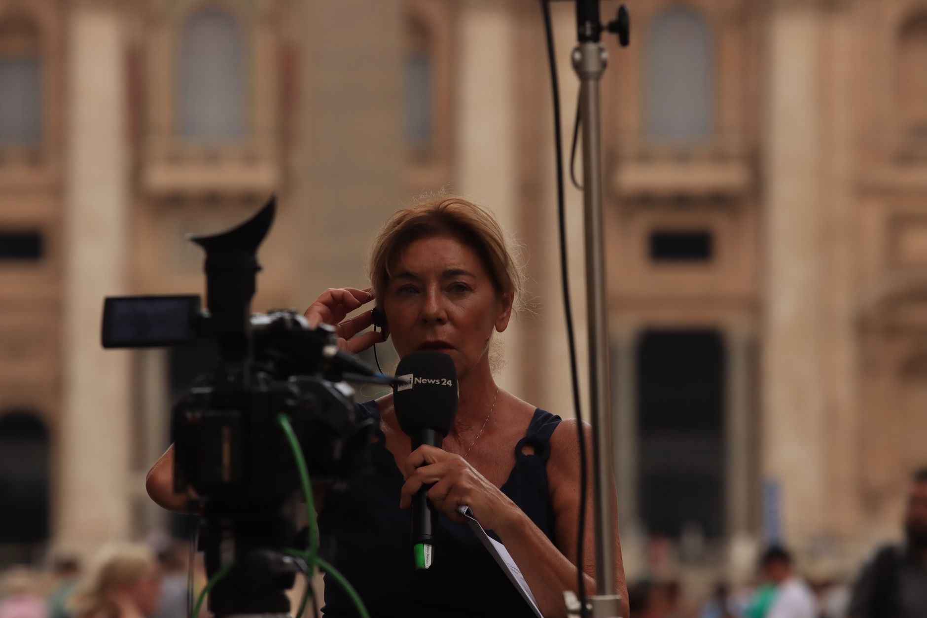 Journalist reporting live from Vatican City, capturing the essence of urban broadcast journalism.
