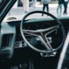 Close-up of a classic Pontiac GTO steering wheel in Kuwait City, capturing retro automotive style.
