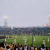 Players and spectators enjoy a vibrant baseball game at Hanshin Koshien Stadium, Japan.