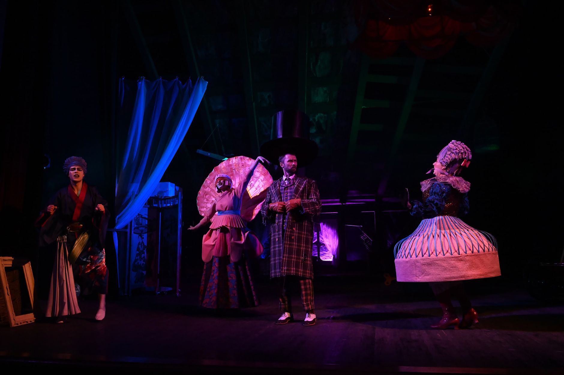 Vibrant costumes and dramatic lighting in a theatrical stage performance.