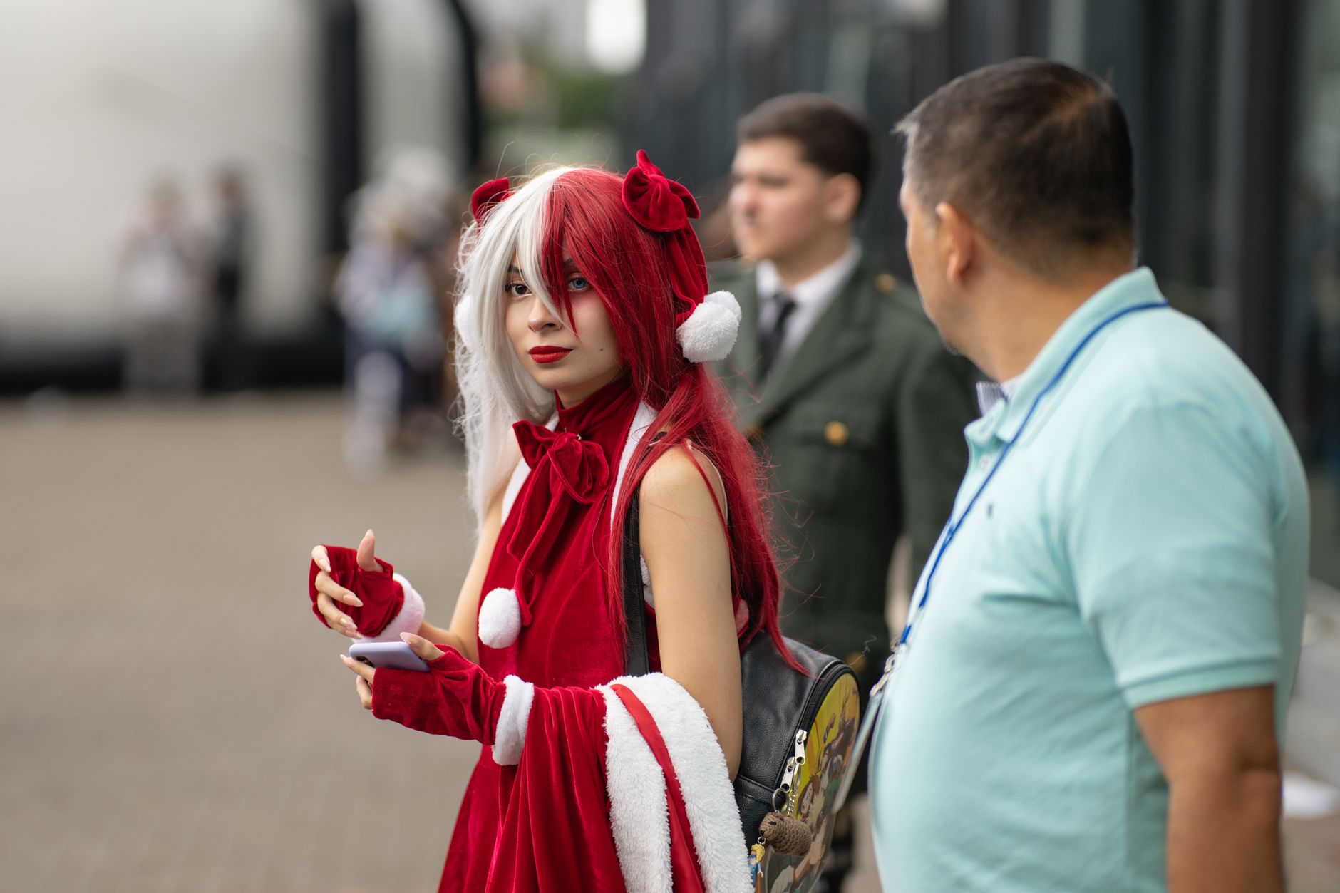 Cosplayer in striking red and white outfit at an outdoor anime event in Costa Rica.