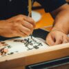 A close-up of an artist skillfully creating Japanese calligraphy with a brush.