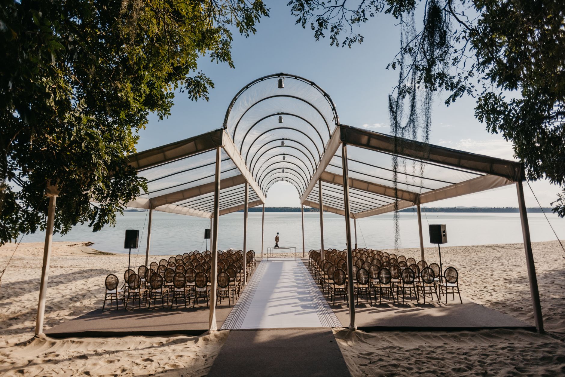 Beautiful open-air beachfront wedding venue with a stylish canopy setup.