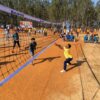 Engaging outdoor volleyball match with active players surrounded by nature.