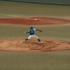 Baseball player mid-throw during a game at a Tokyo baseball field. Capturing the intensity and focus of sports.