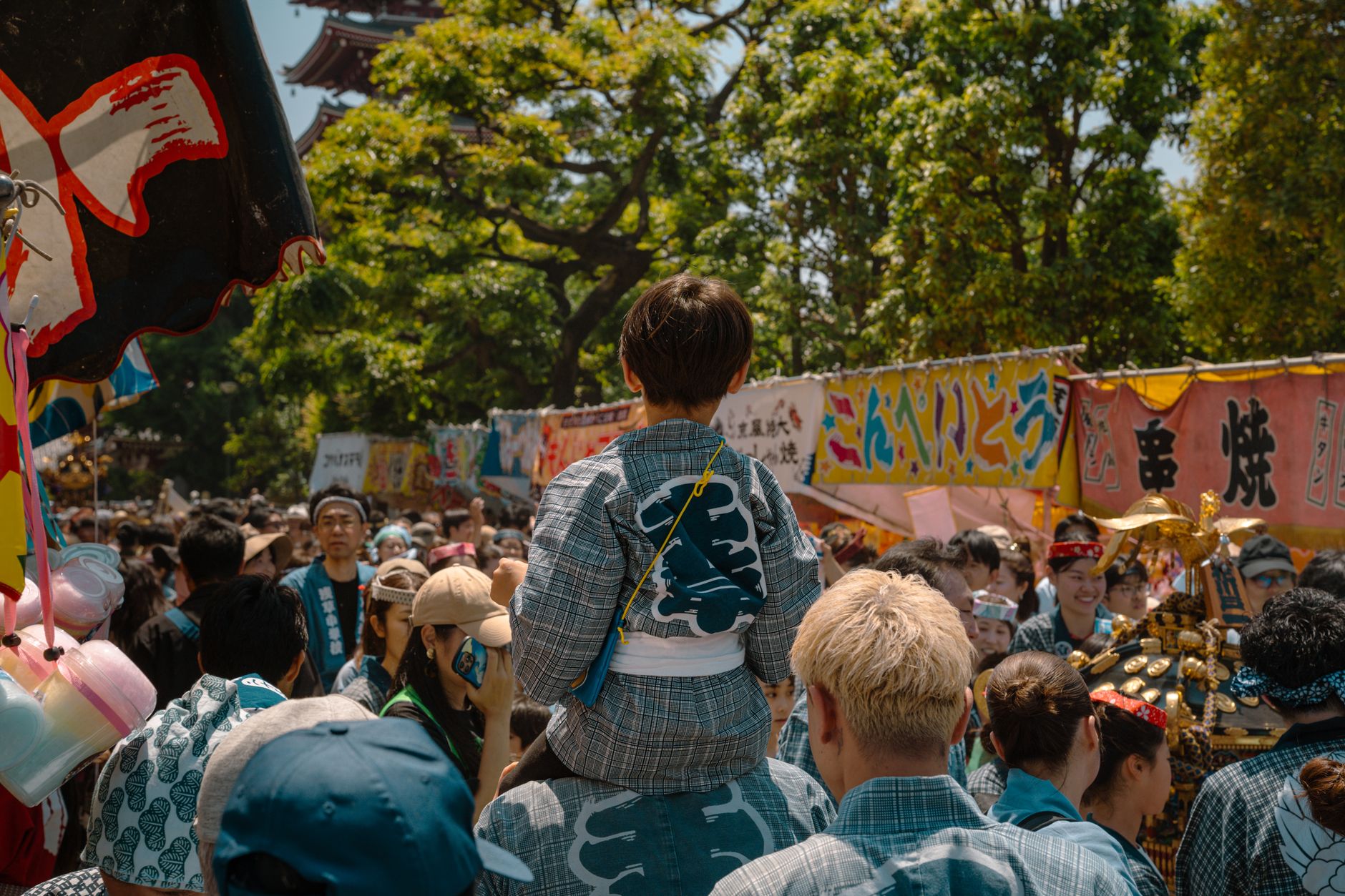 People celebrating a traditional festival in Tokyo, Japan, at a vibrant outdoor event.