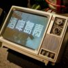 Retro CRT TV with Asian script displayed on the screen, evoking nostalgia and vintage tech vibes.