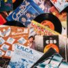 Top view composition of old fashioned vinyl discs in colorful packs heaped on table