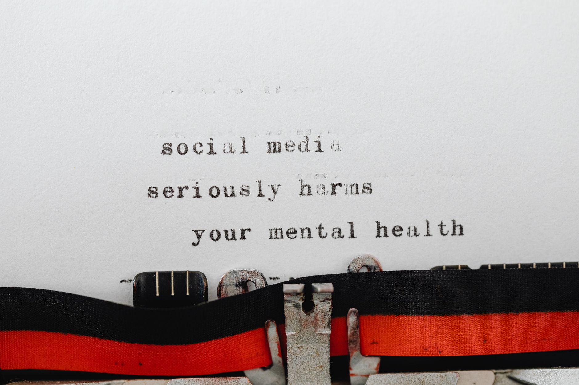 Vintage typewriter conveying message on social media's impact on mental health.