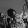 A dramatic black and white photograph capturing conflict and tension among diverse women.