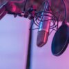 A close-up view of a microphone in a vibrant studio environment, ideal for podcasts and voice recording.